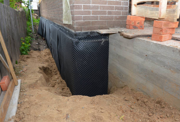 Happy homeowners after waterproofing job in Commiskey
